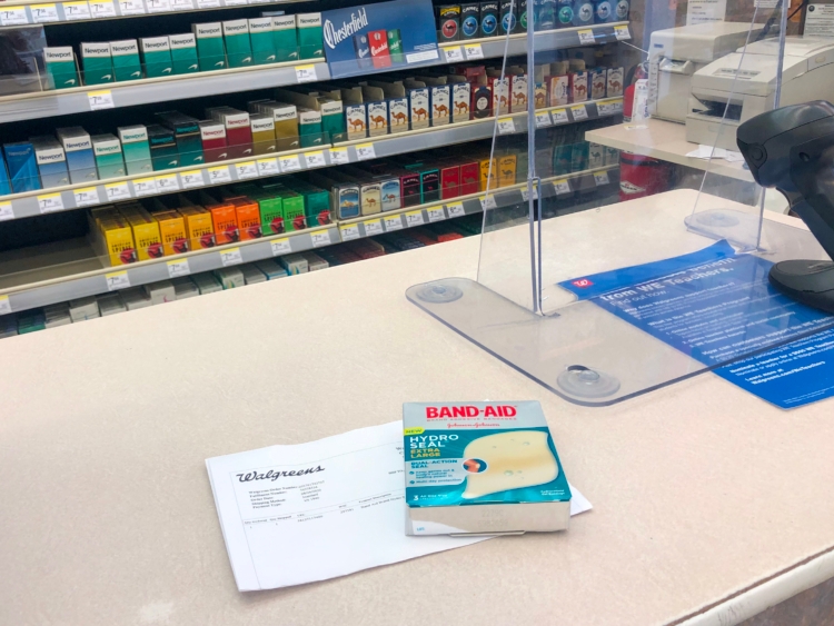 Band-aids sitting on a checkout counter with an online receipt