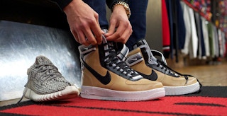 Someone trying on shoes in a Flight Club sneaker shop