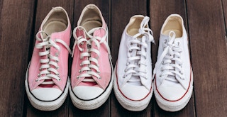 two pairs of dirty converse sneakers