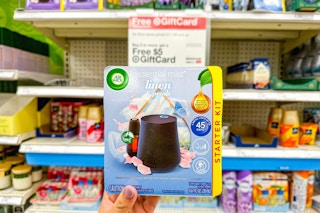 hand holding an air wick essential mist diffuser kit at target