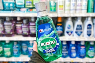 hand holding a bottle of crest scope mouthwash