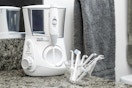 a white water flosser on a bathroom counter