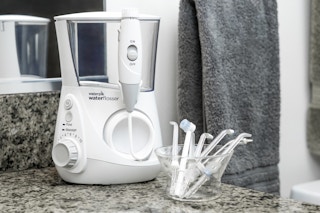 a white water flosser on a bathroom counter