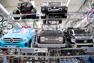 a variety of power wheels ride-on cars on display at Walmart
