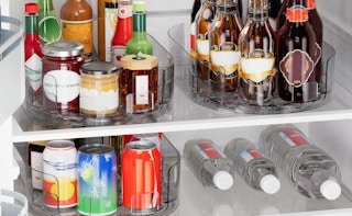 jars and bottles on lazy Susans in a fridge 