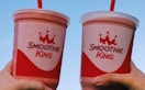 two people holding smoothie king cups. taken from their instagram