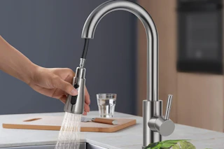 a kitchen faucet being used