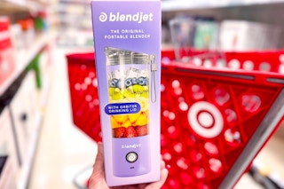 hand holding a blendjet portable blender in front of target cart
