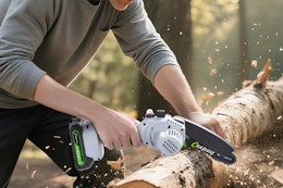 a person using a chainsaw on a log