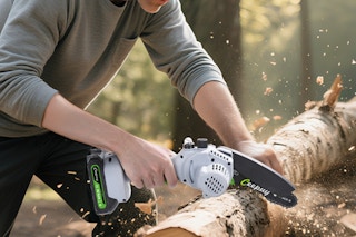 a person using a chainsaw on a log