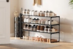 rack holding an assortment of shoes by entryway