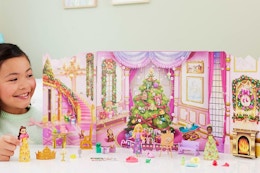 a girl playing with a disney princess advent calendar
