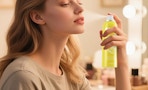 a person spraying makeup setting spray