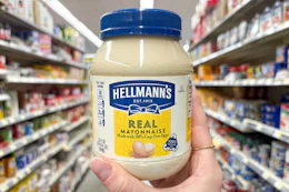 hand holding up a jar of hellmann's mayonnaise