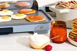 Lifestyle image of the Cornflower Blue Beautiful Electric Griddle with food surrounding