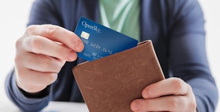 A person taking an OpenSky credit card out of a wallet