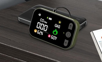 a gas and carbon monoxide detector plugged into a wall 