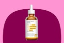 bottle of serum on pink and maroon background