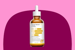 bottle of serum on pink and maroon background