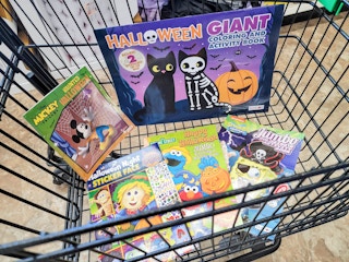 a cart with halloween activity and coloring books
