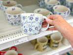 hand holding an i love you mom mug in front of a target shelf