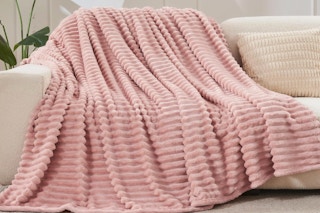 NEWCOSPLAY Super Soft Throw Blanket draped on a couch.