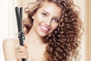 a woman using a curling iron