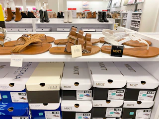 three pairs of shoes on a shelf display with boxes of shoes below in jcpenney