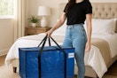 a woman holding a large moving bag