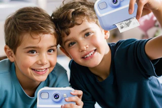 boys playing with an instant camera