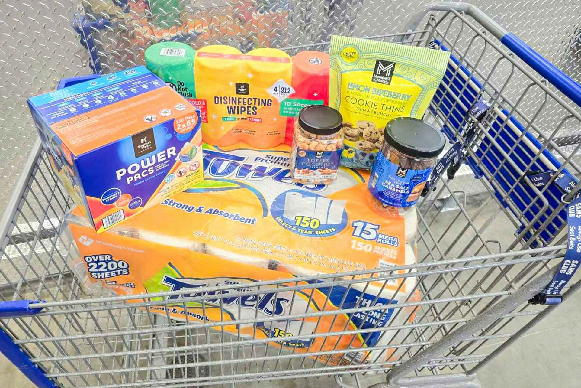 cart full of members mark products at sams club including snacks, paper towels, and more