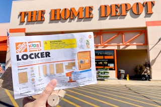 A free kids workshop kit held in front of the home depot.
