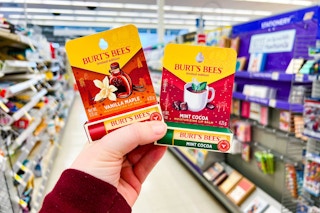 hand holding two burt's bees holiday lip balms