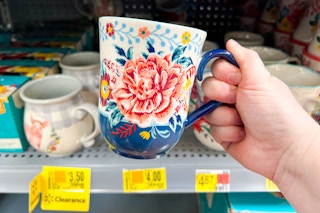 Floral Coffee Mug held up in front of other clearanced mugs at Walmart