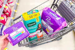 hand holding poise pads next to poise and depend products sponsored