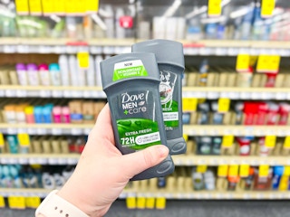 dove deodorant held in hand