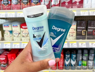 hand holding two Degree deodorants in aisle