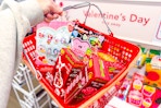 hand holding basket with valentine's day crafts