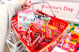 hand holding basket with valentine's day crafts