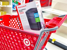 honeywell allergen plus air purifier sitting on top a target cart