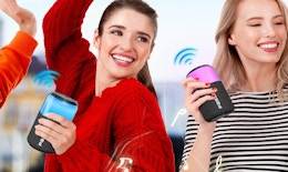 two people holding portable speakers 