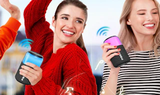 two people holding portable speakers 