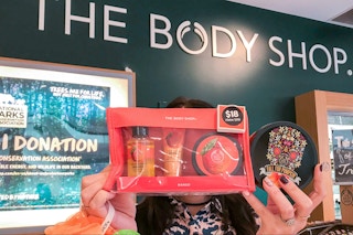 Someone holding up products in a The Body Shop store