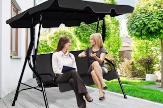 two women on a patio swing 