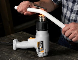 a person using a heat gun