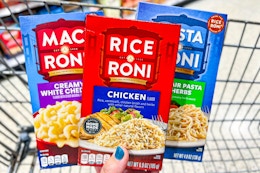 hand holding boxes of rice a roni