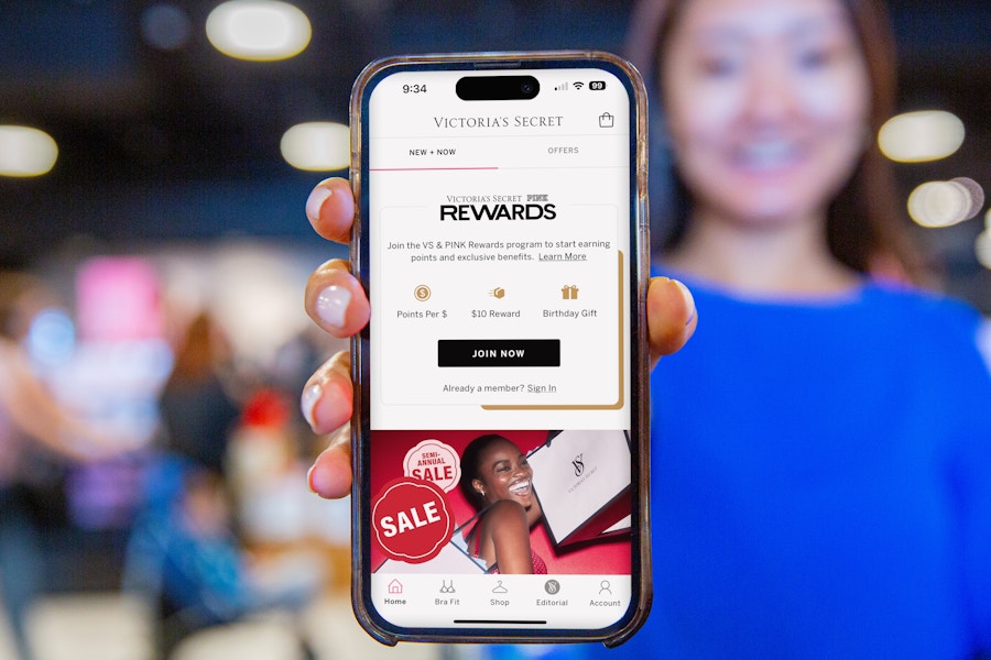 someone holding up a phone showing the victoria's secret app