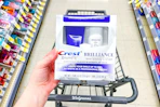 hand holding crest brilliance whitening kit in walgreens