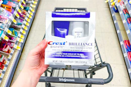 hand holding crest brilliance whitening kit in walgreens
