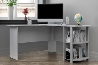 lifestyle image of a grey desk set up with a computer and books on it